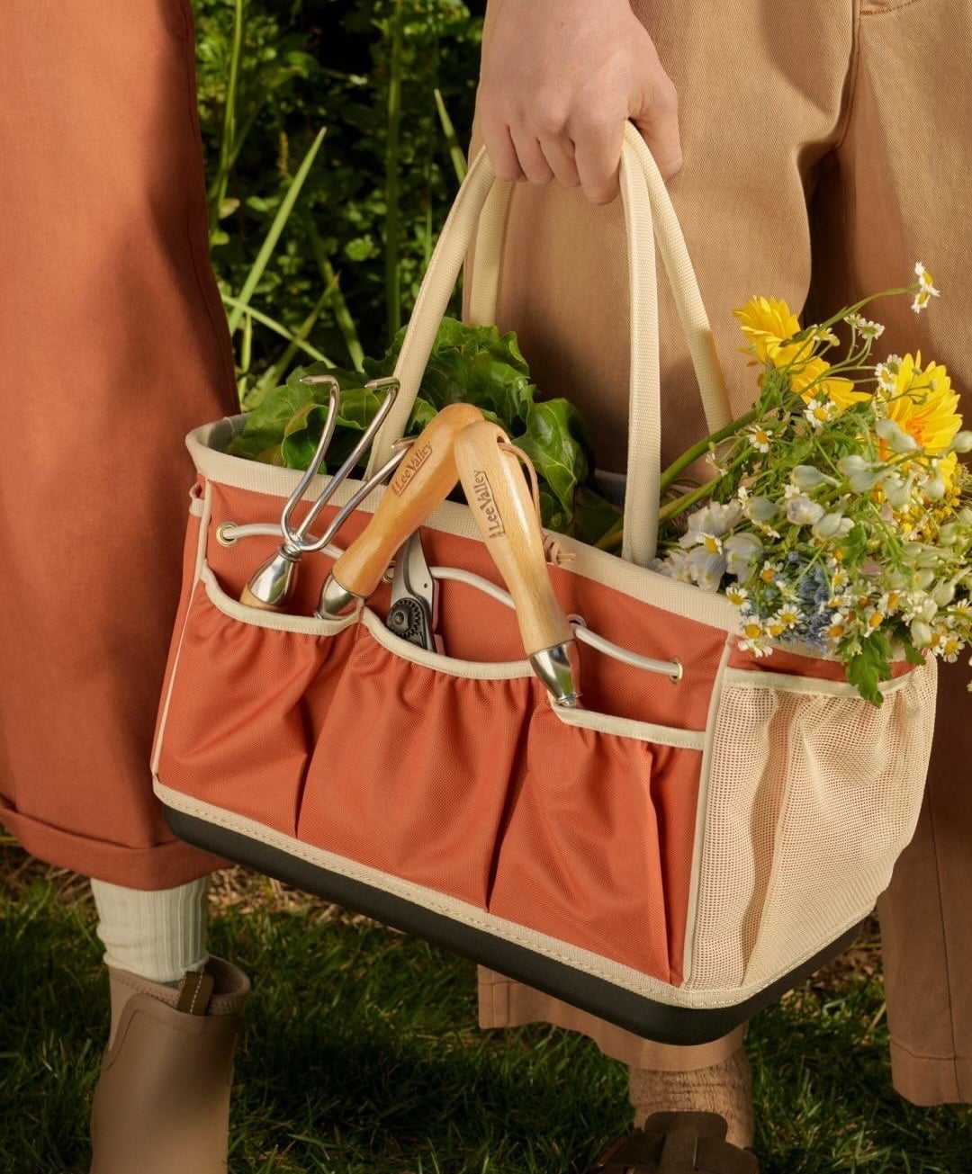 A person holding the gardening bag