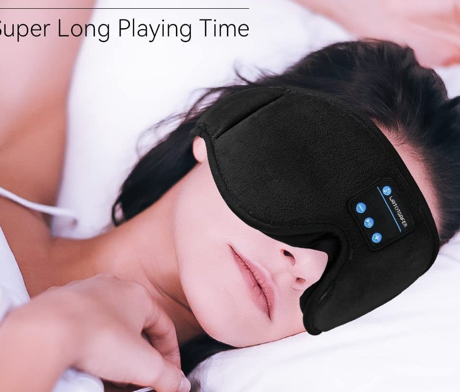 a person sleeping while wearing the eye mask/headphone combo