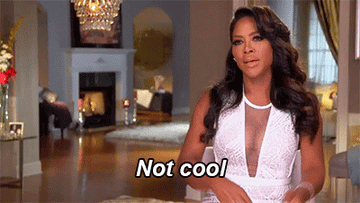 Kenya Moore saying not cool with her hands in a cross
