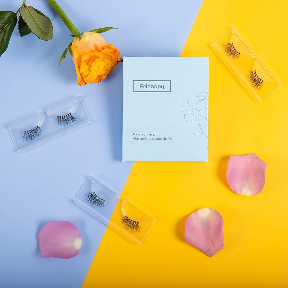 The pack of lashes surrounded by lashes and flower petals