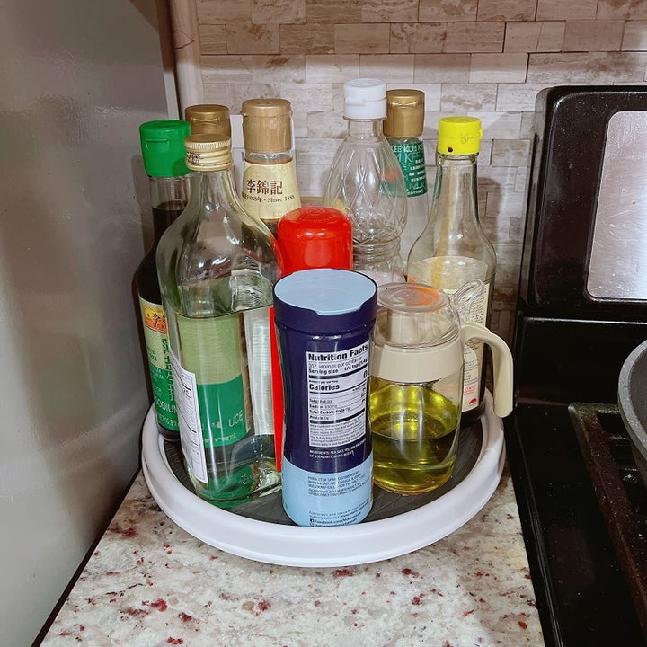 Reviewer image of lazy Susan filled with various seasonings next to stove