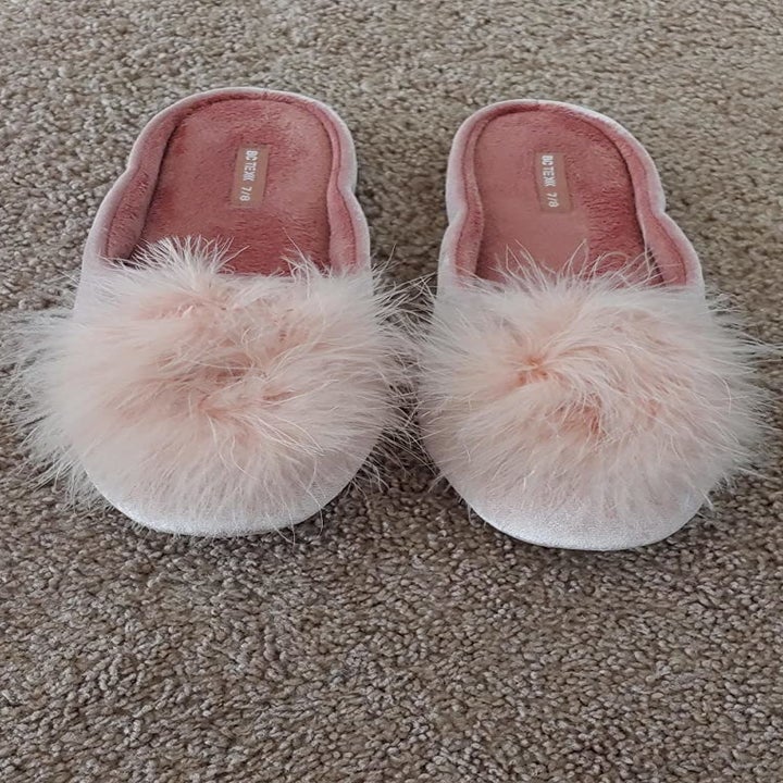 Reviewer image of pink slippers with pom-poms