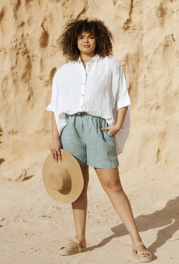 a person wearing the linen shorts in teal