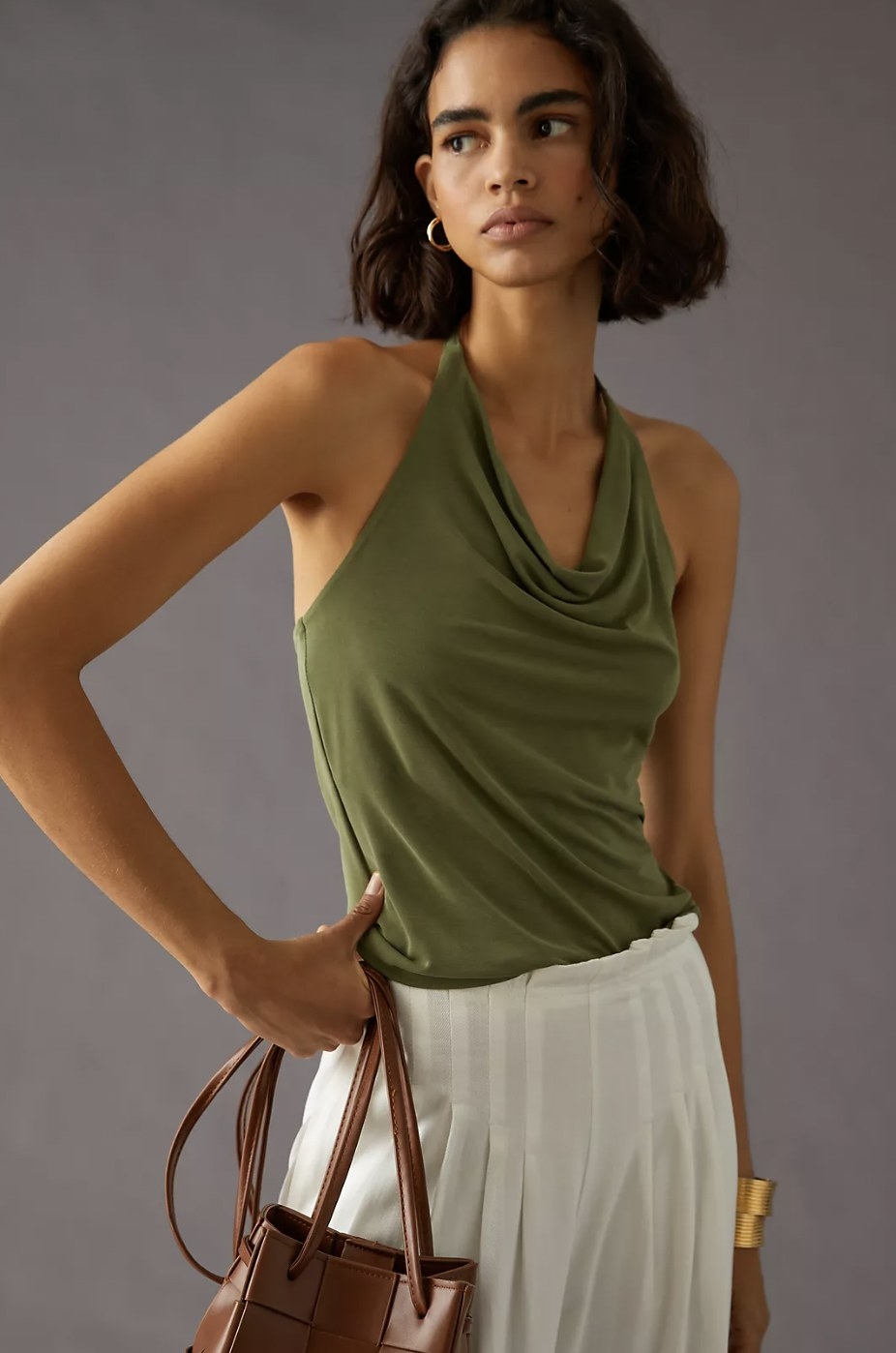 a model wearing the top in green