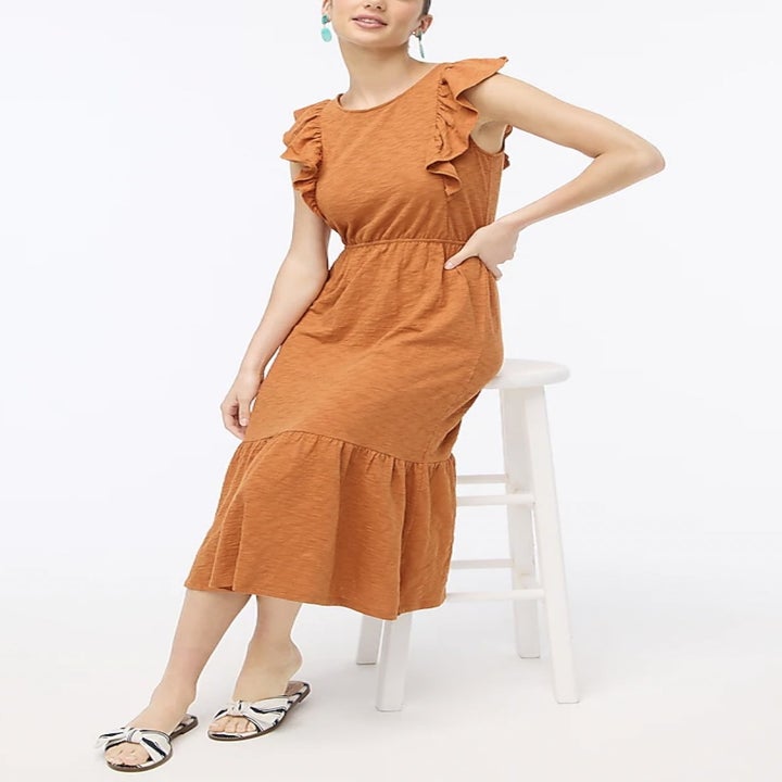 a model sitting down while wearing the dress