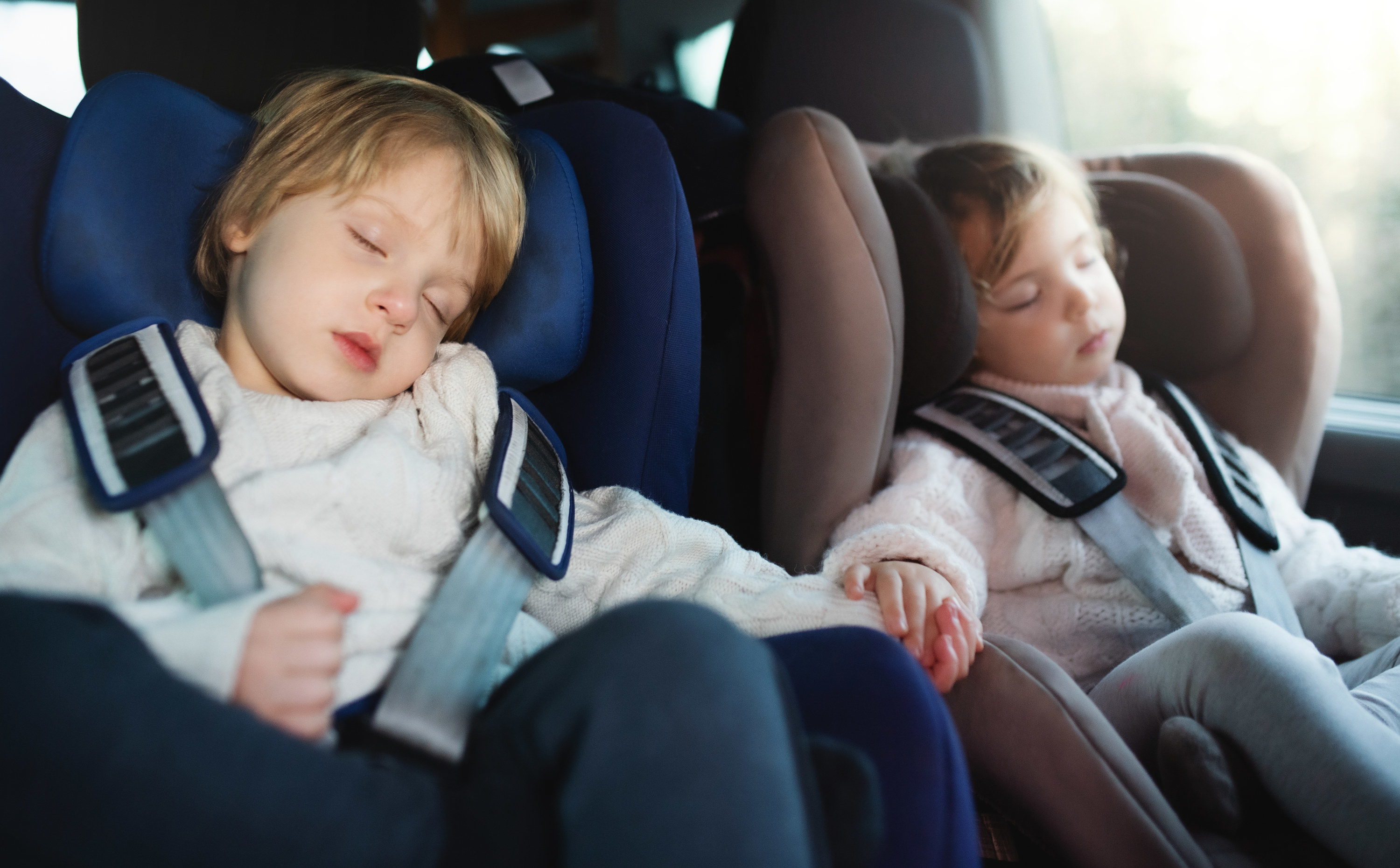 kids asleep in the back of a car
