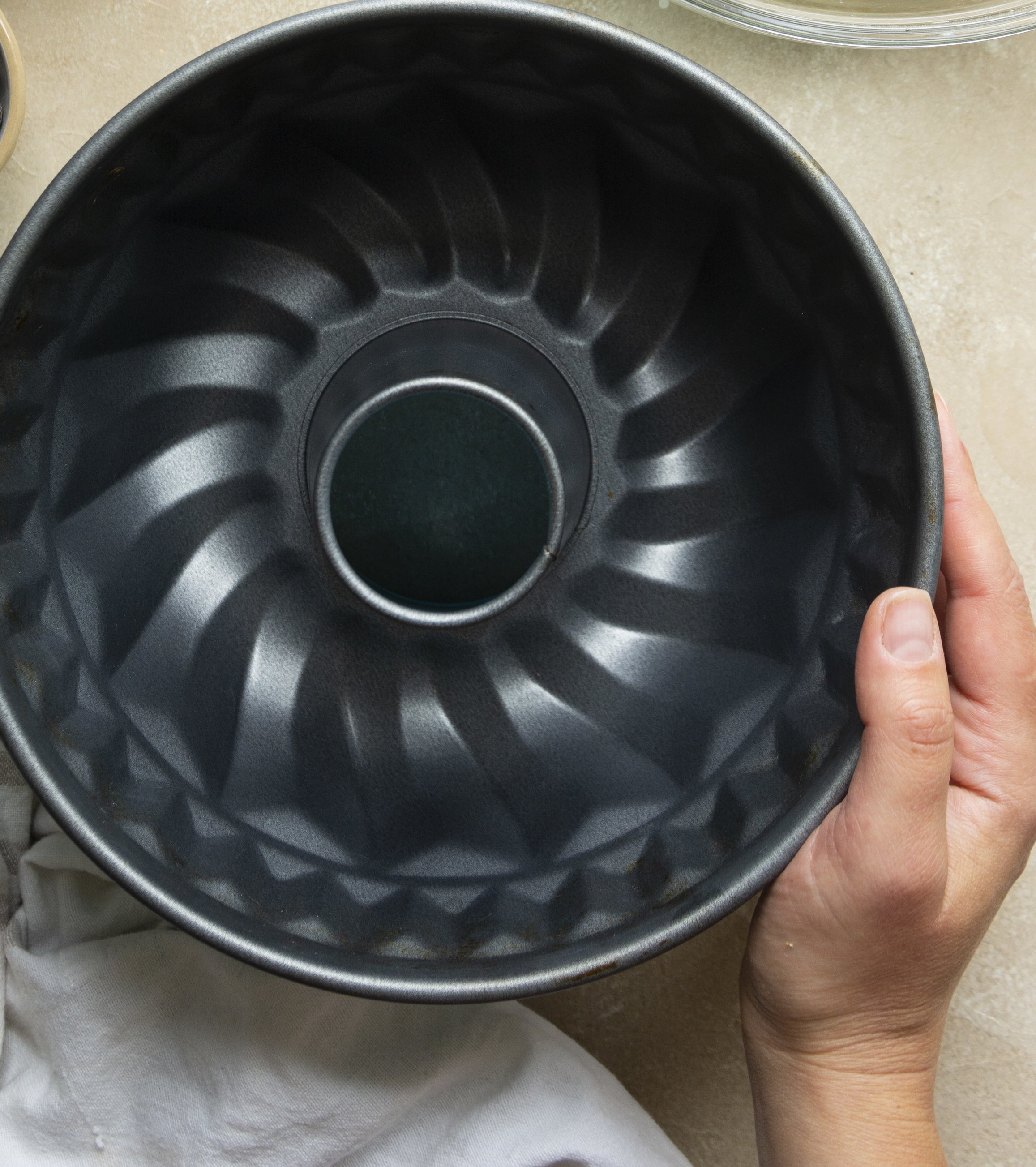 Person holding a Bundt pan in the kitchen