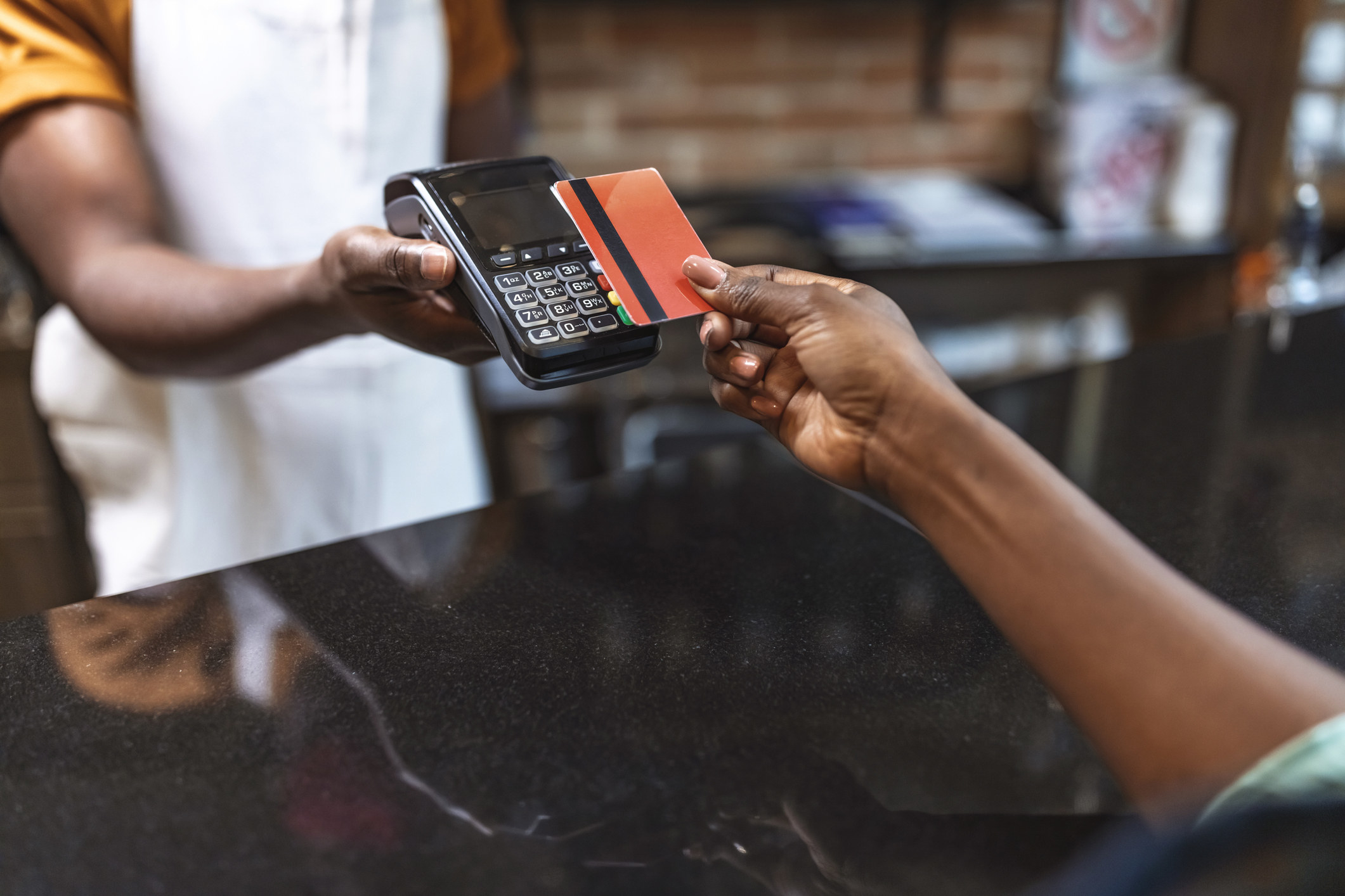A woman paying with a credit card.