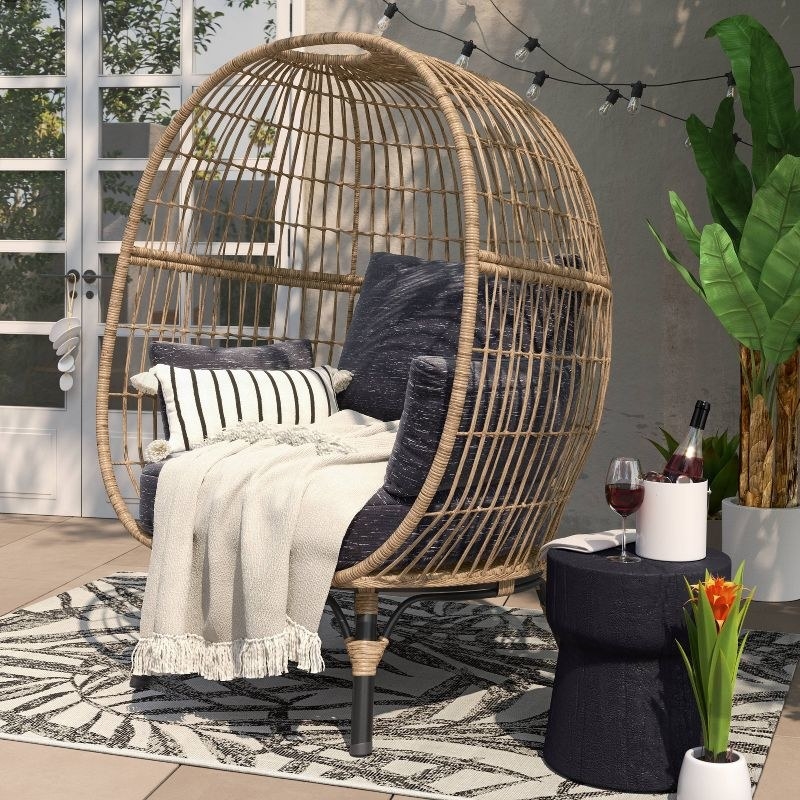 the black and white rug on a patio with an egg chair on top