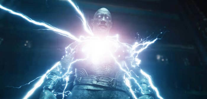 Black Adam&#x27;s eyes glow and his body pulses with electricity