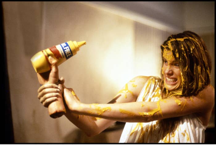 A woman covered in mustard battles a disembodied hand in the opening scene of &quot;Waxwork II: Lost in Time&quot;