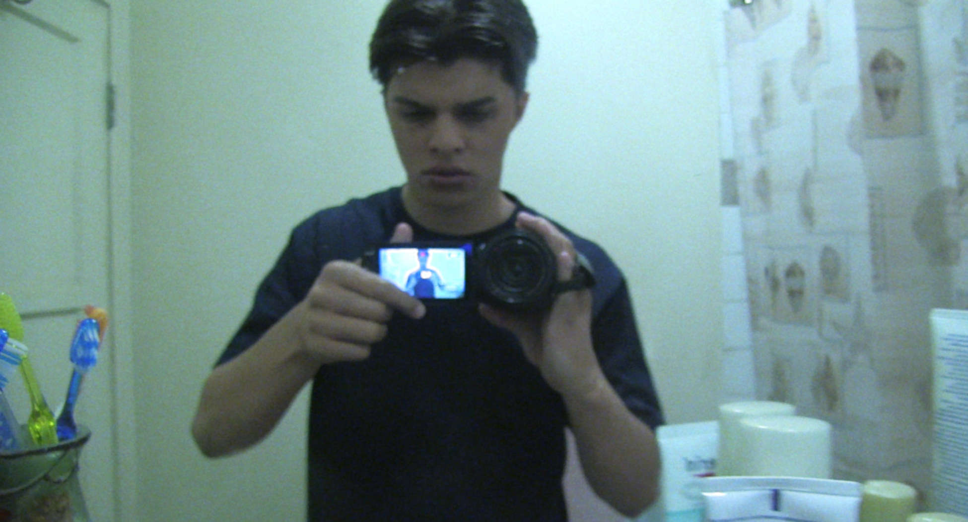 A teenager examines scary physical changes in the bathroom mirror in &quot;Paranormal Activity: The Marked Ones&quot;