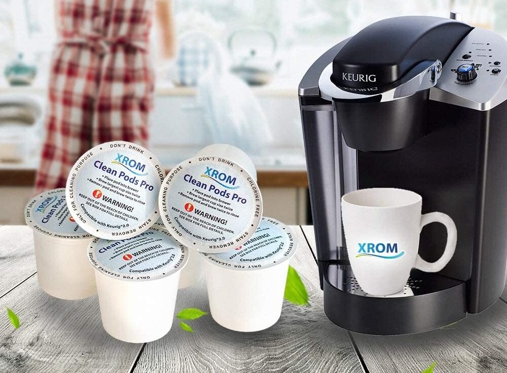 The pods beside a Keurig machine on a counter