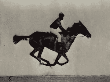 a black man in a jockey uniform riding a horse