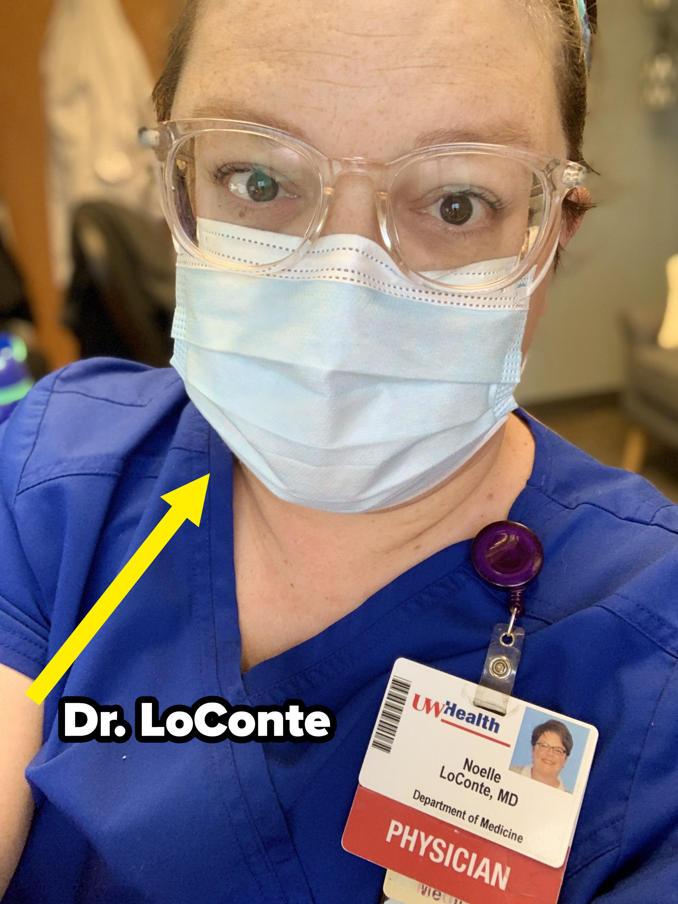 A closeup of Dr. LoConte wearing scrubs and a face mask