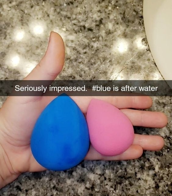 Reviewer&#x27;s photo of their blue sponge looking extra large compared to the pink sponge with caption &quot;seriously impressed. blue is after water&quot;