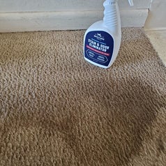a reviewer photo showing the bottle on a dirty carpet