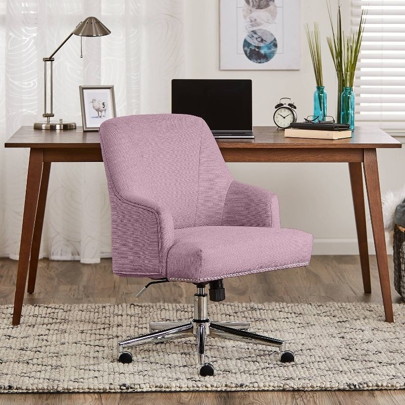 a lilac office chair next to a wooden desk