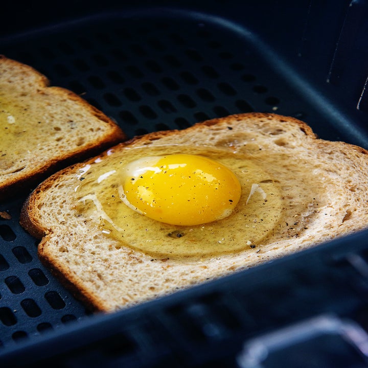 An egg on toast in an air fryer.