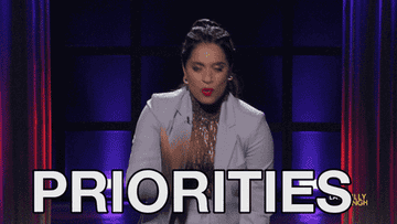 A gif of Lilly Singh saying &quot;priorities&quot;