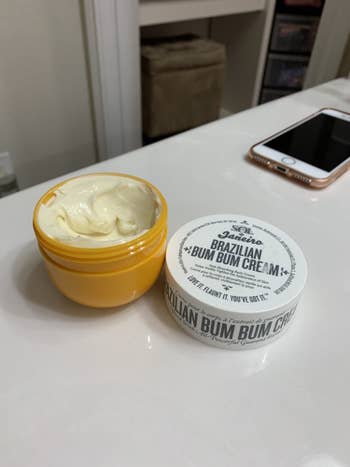 A reviewer's photo of the white product in a yellow jar