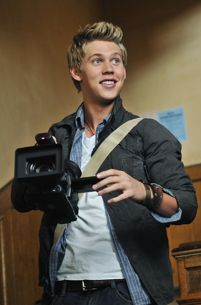 close up of Austin holding a large camera