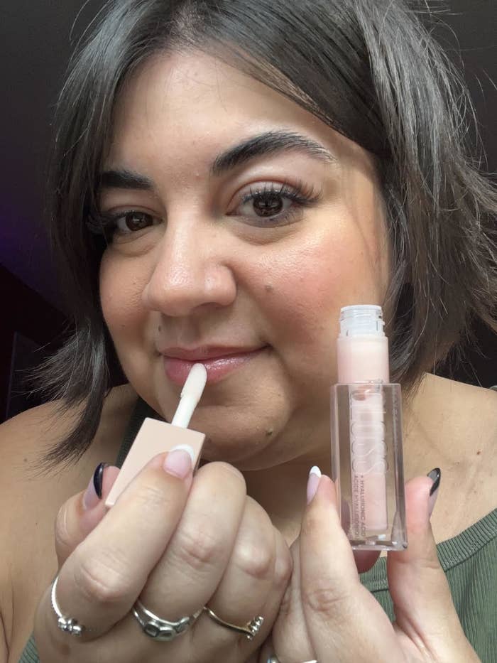 Bianca putting the lip gloss on her lips