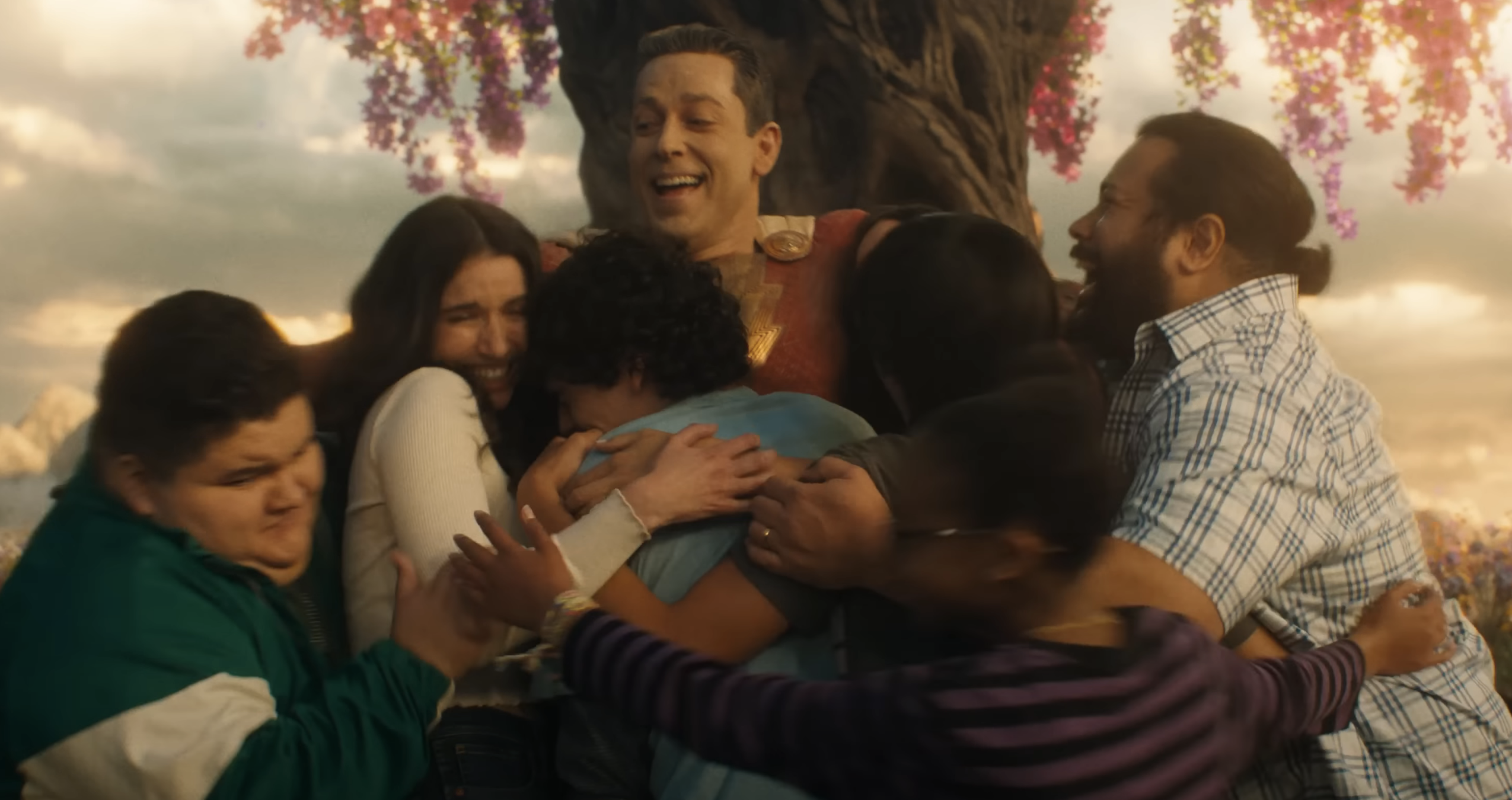 Zachary hugging several people at once in a scene from the film