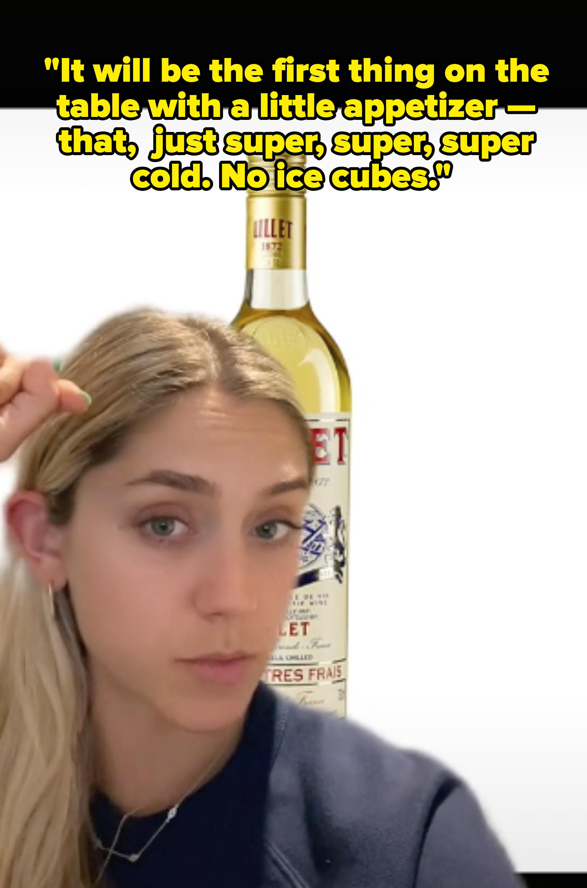 Screenshot of Claire&#x27;s TikTok with her in front of a bottle of Lillet with quote: It will be the first thing on the table with a little appetizer — that, just super, super, super cold, no ice
