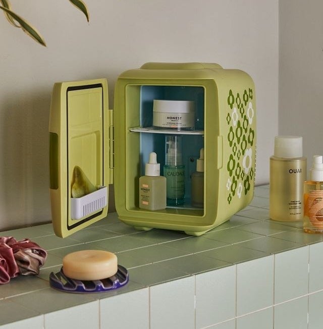 an adorable mini fridge filled with skincare products on a counter top