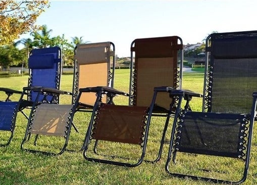 four chairs in a row on a big lawn