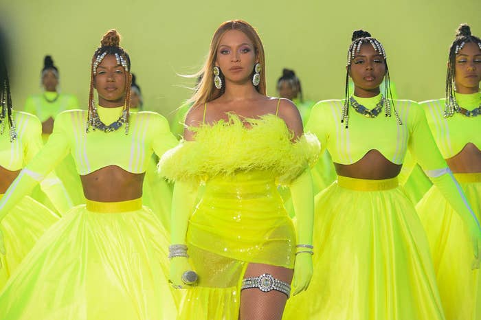 Beyoncé poses in a lime green mini dress surrounded by dancers