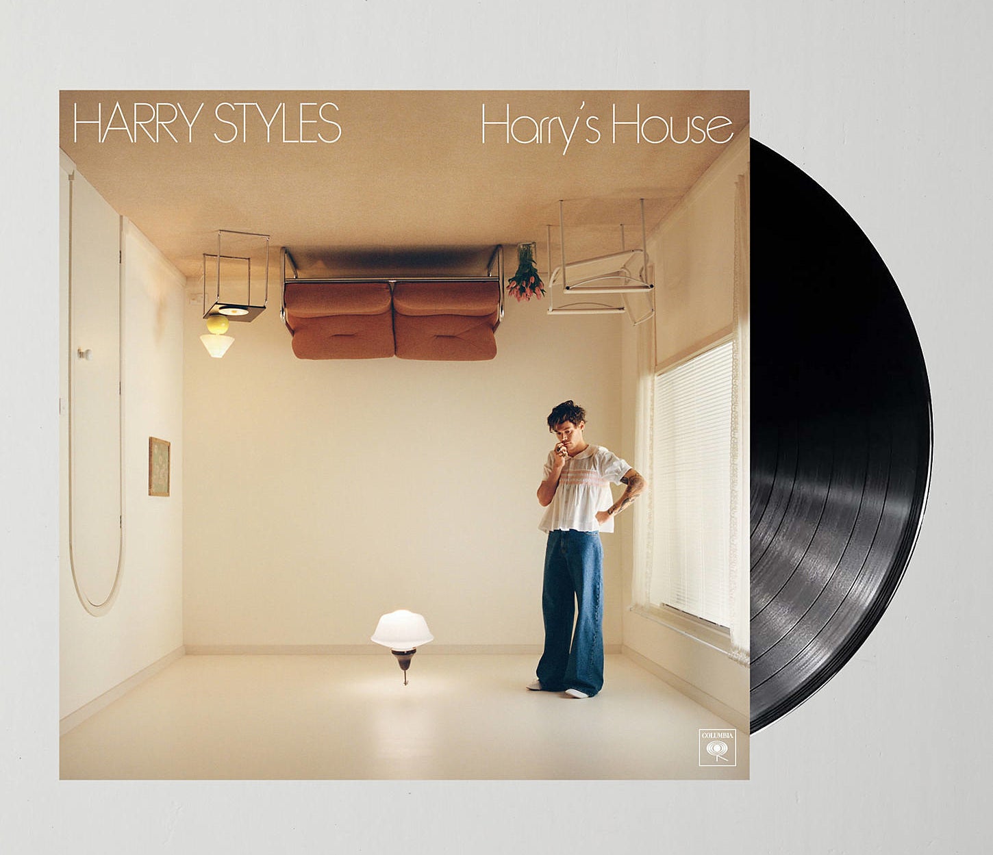 the cover of harry styles harry&#x27;s house with a record half-way out of it