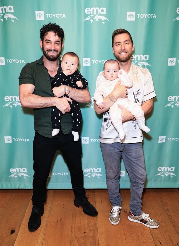 Michael Turchin and Lance Bass hold their twins at the Environmental Media Association IMPACT Summit And Cocktail Reception in June 2022