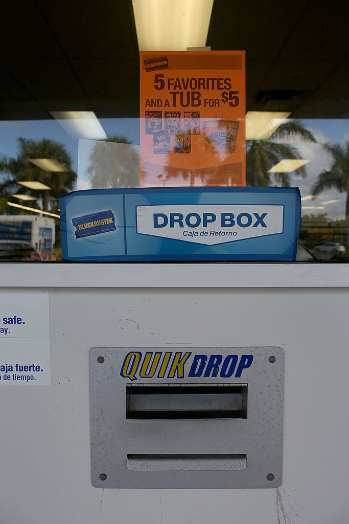 A Blockbuster Quik Drop slot below a &quot;Drop Box&quot; sign in the window