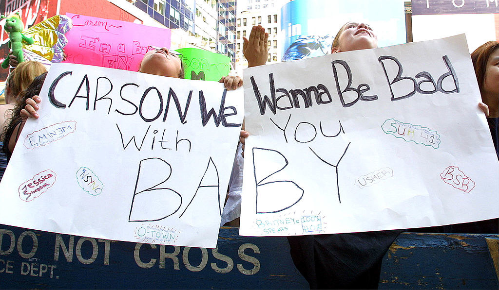 Two signs together read &quot;Carson we wanna be bad with you baby&quot;