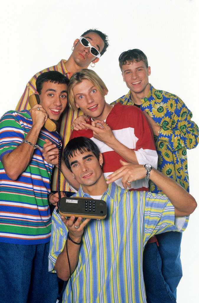 The Backstreet Boys with a very large cellphone