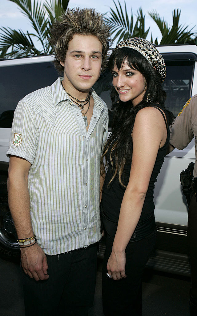 Ryan, not smiling, and Ashley, who is smiling, standing together