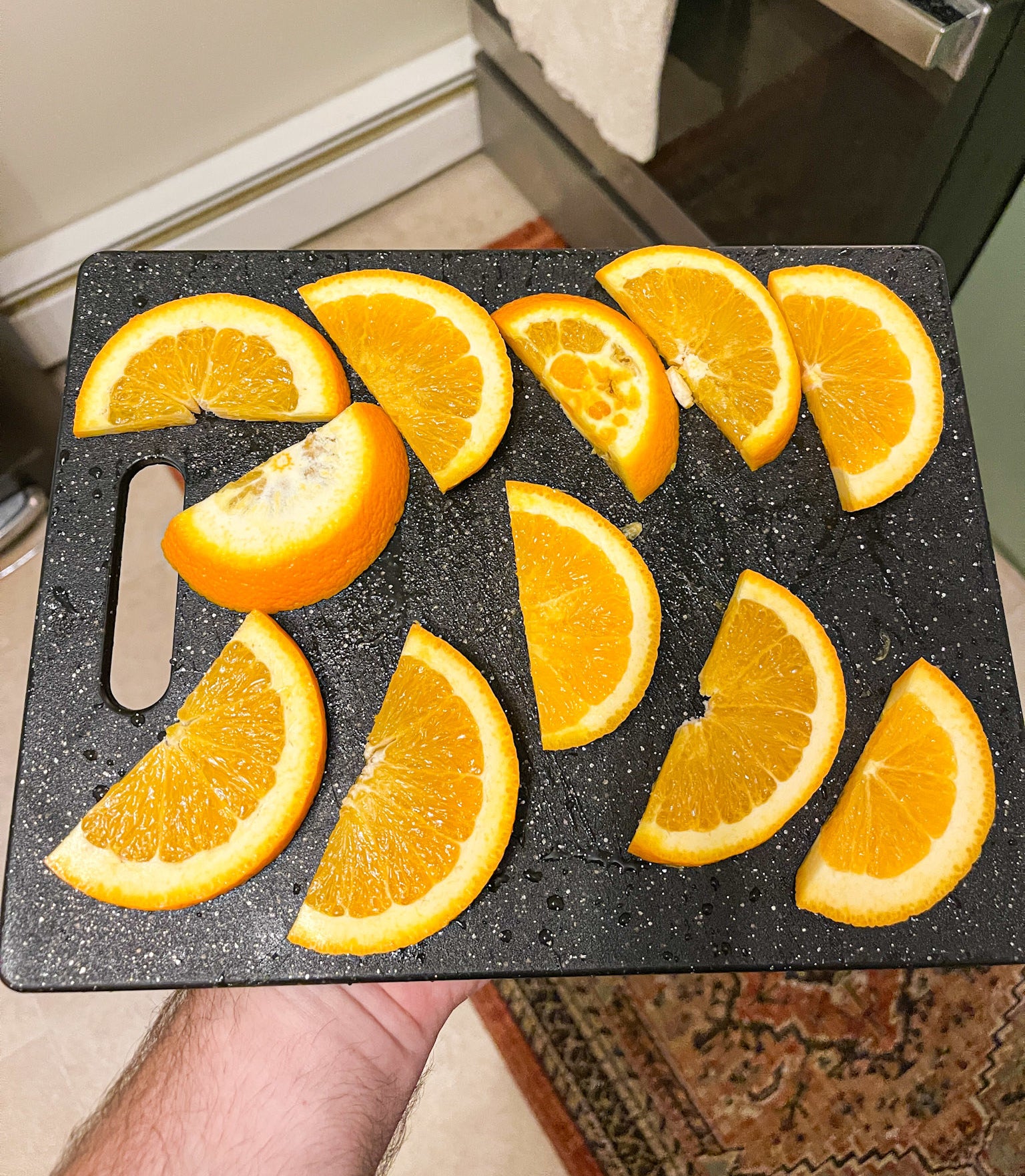 Several orange slices on a cutting board