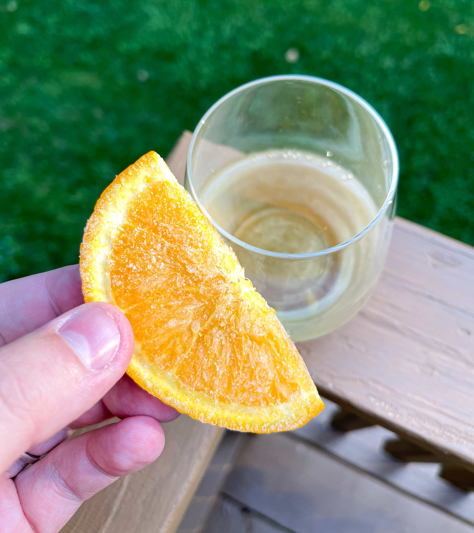 Adding frozen orange to glass of Lillet