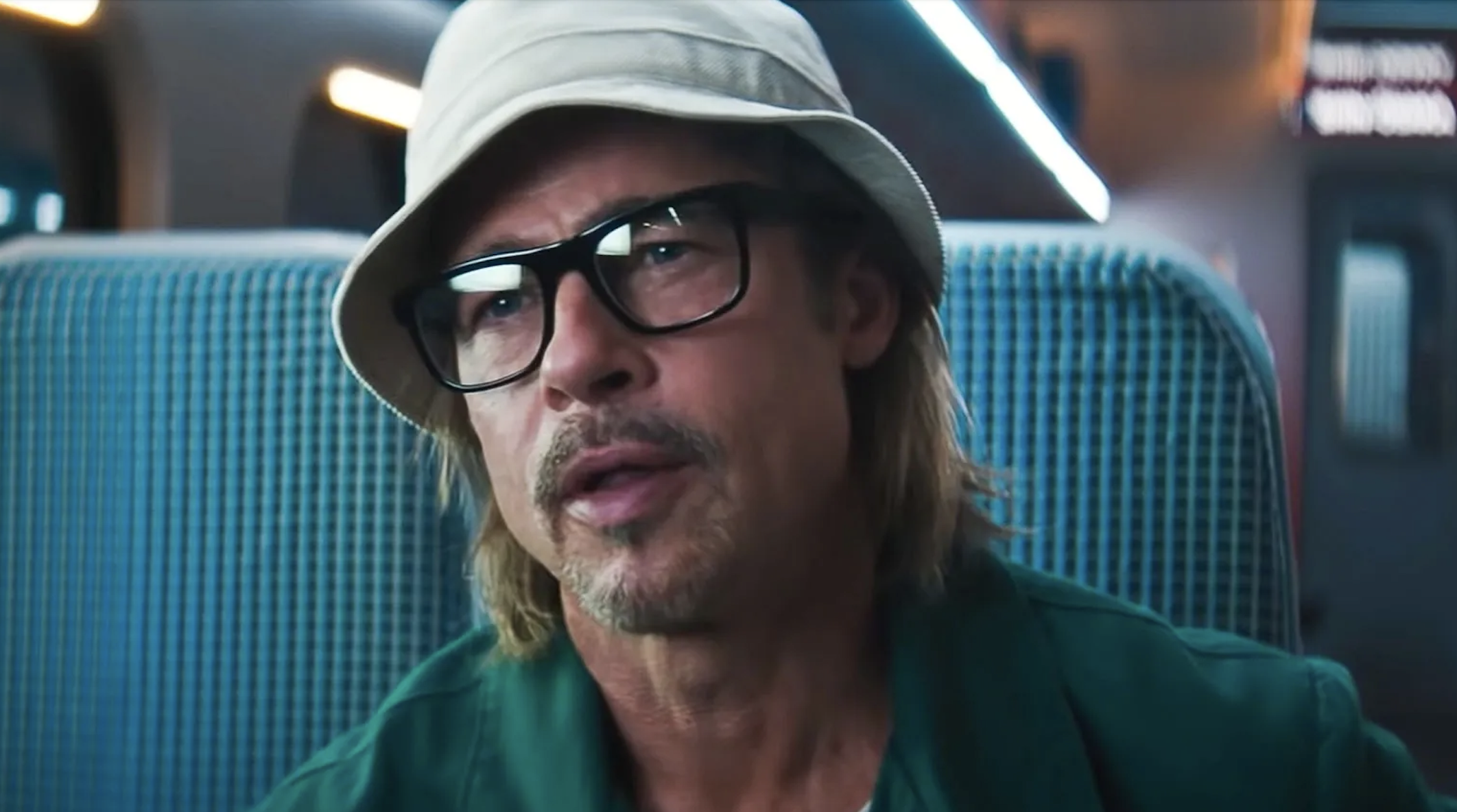 Brad Pitt as Ladybug sitting on a train in &quot;Bullet Train&quot;