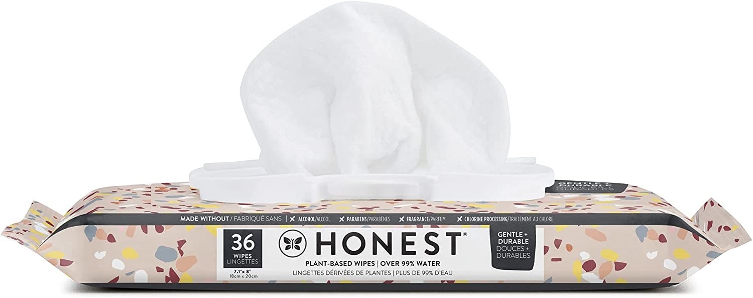 A package of Honest baby wipes with a wipe coming out of the opening