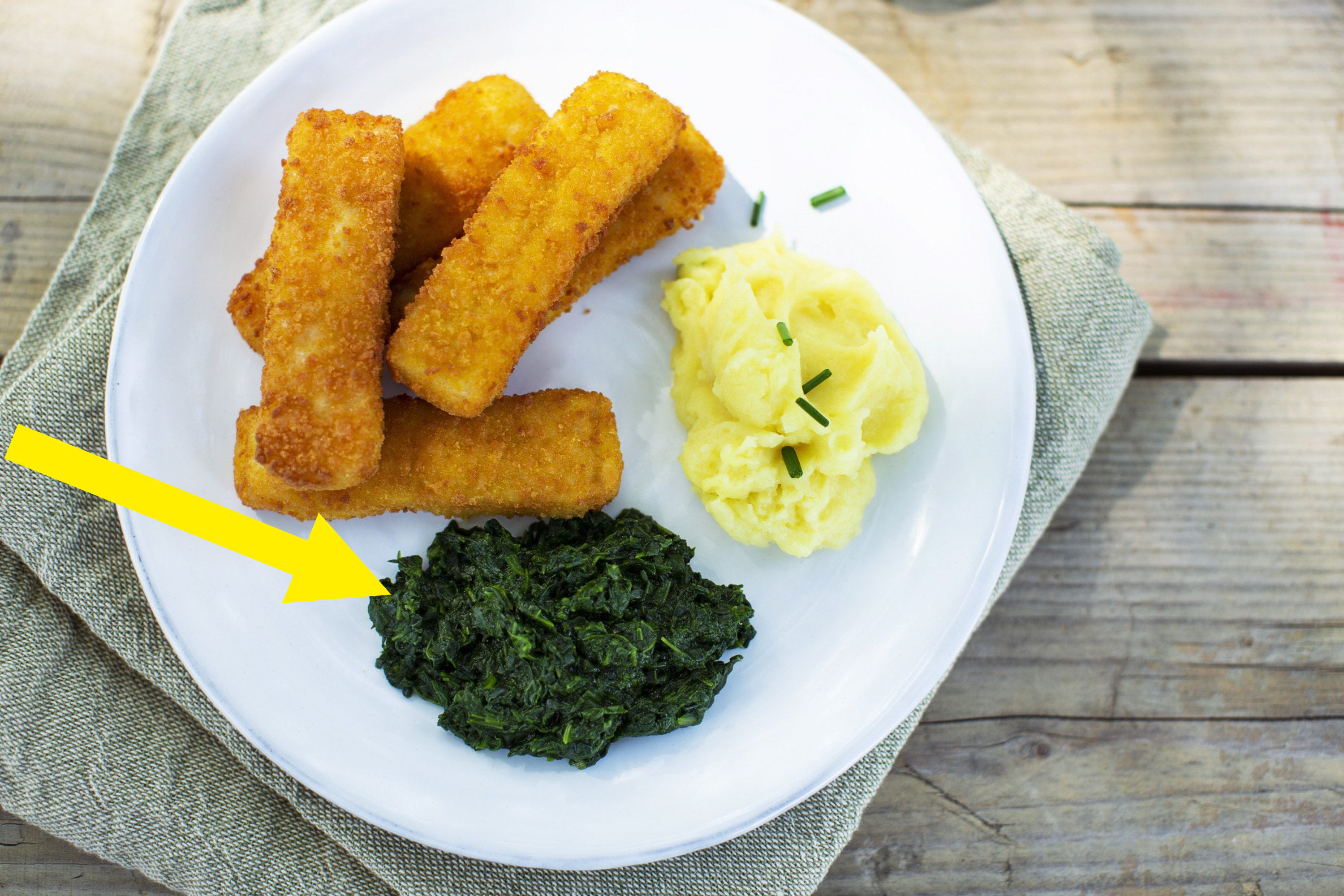 Fish sticks with mashed potatoes and spinach.