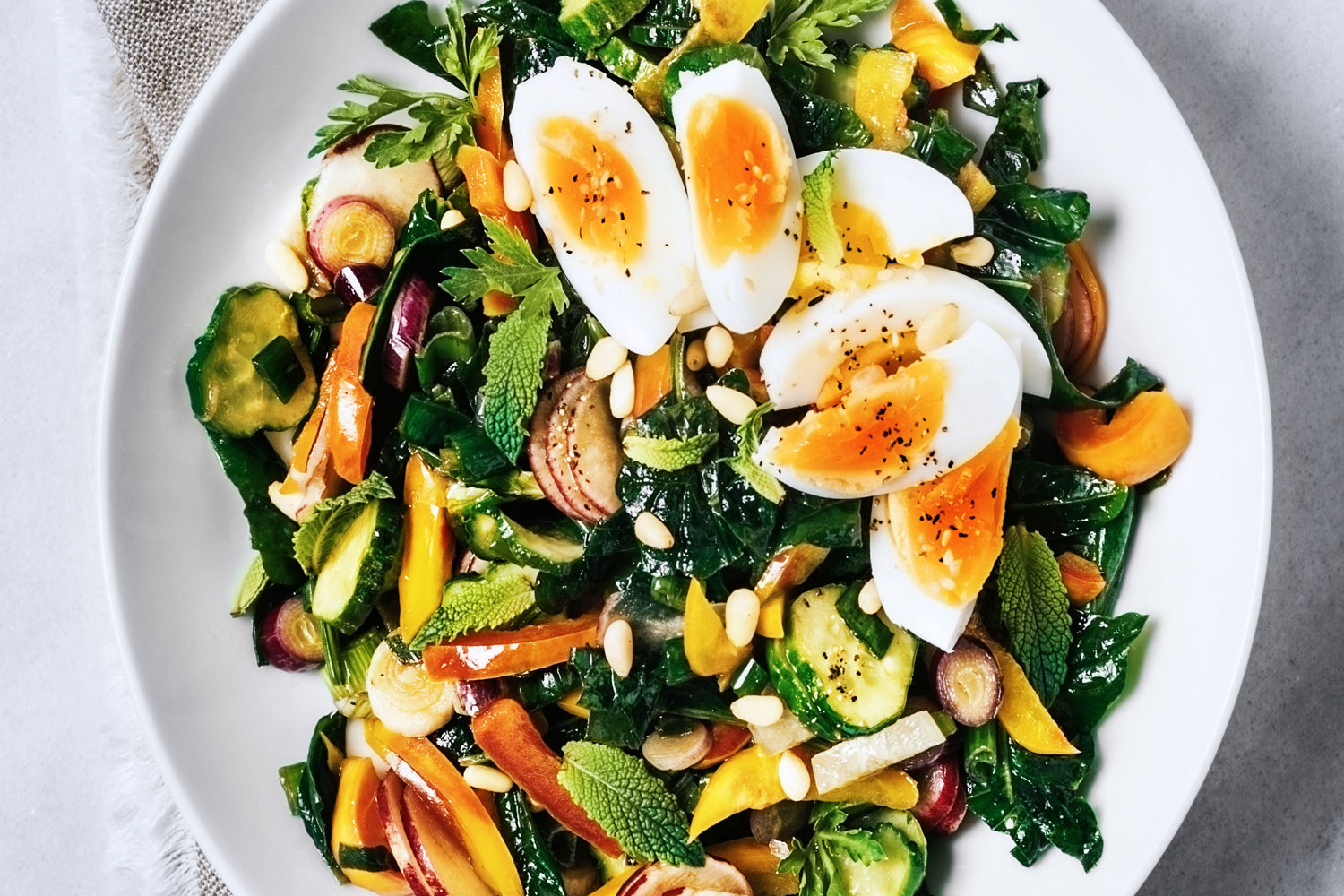 A vegetarian salad with eggs and lots of veggies.