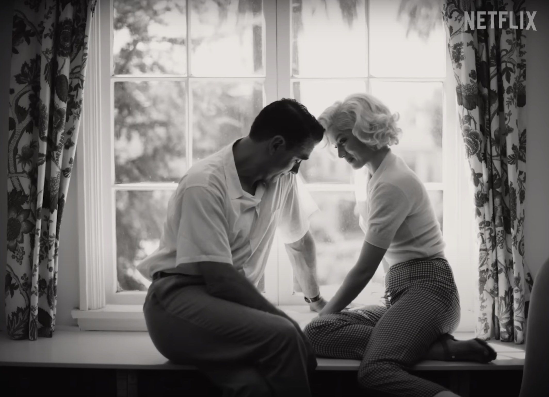 Ana as Marilyn posing in a window frame with Joe