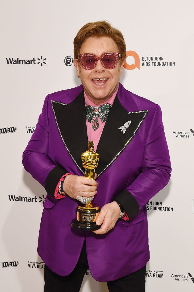 Elton holding an award