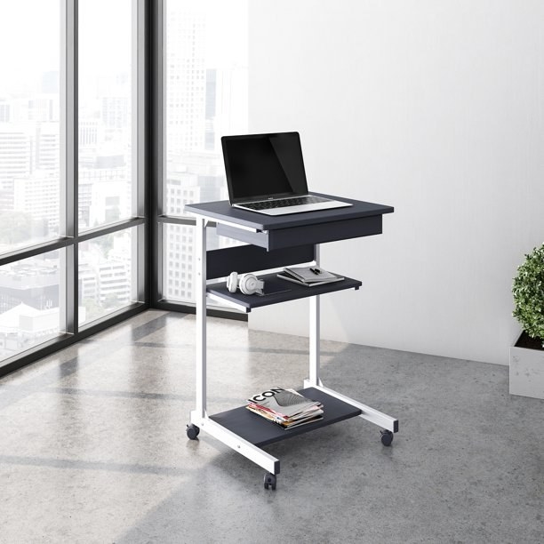 a gray rolling desk with three shelves and next to a high-rise window