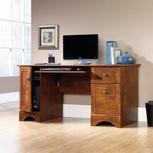 a brushed maple wooden and metal desk in a home office