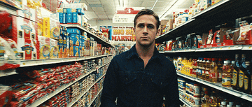 A man walking down a grocery aisle.