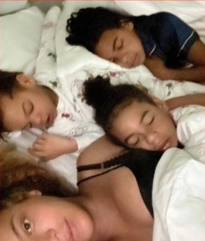 Beyonce lies in bed with her three sleeping children